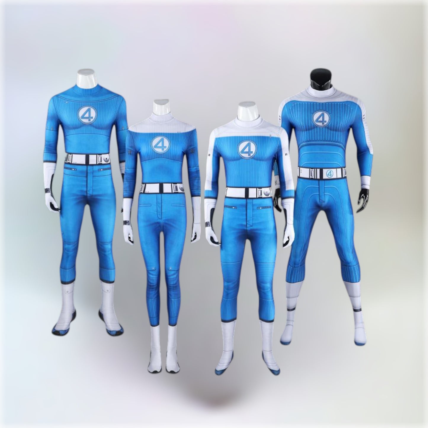 All costumes of the Fantastic Four team displayed on mannequins with a light grey background.