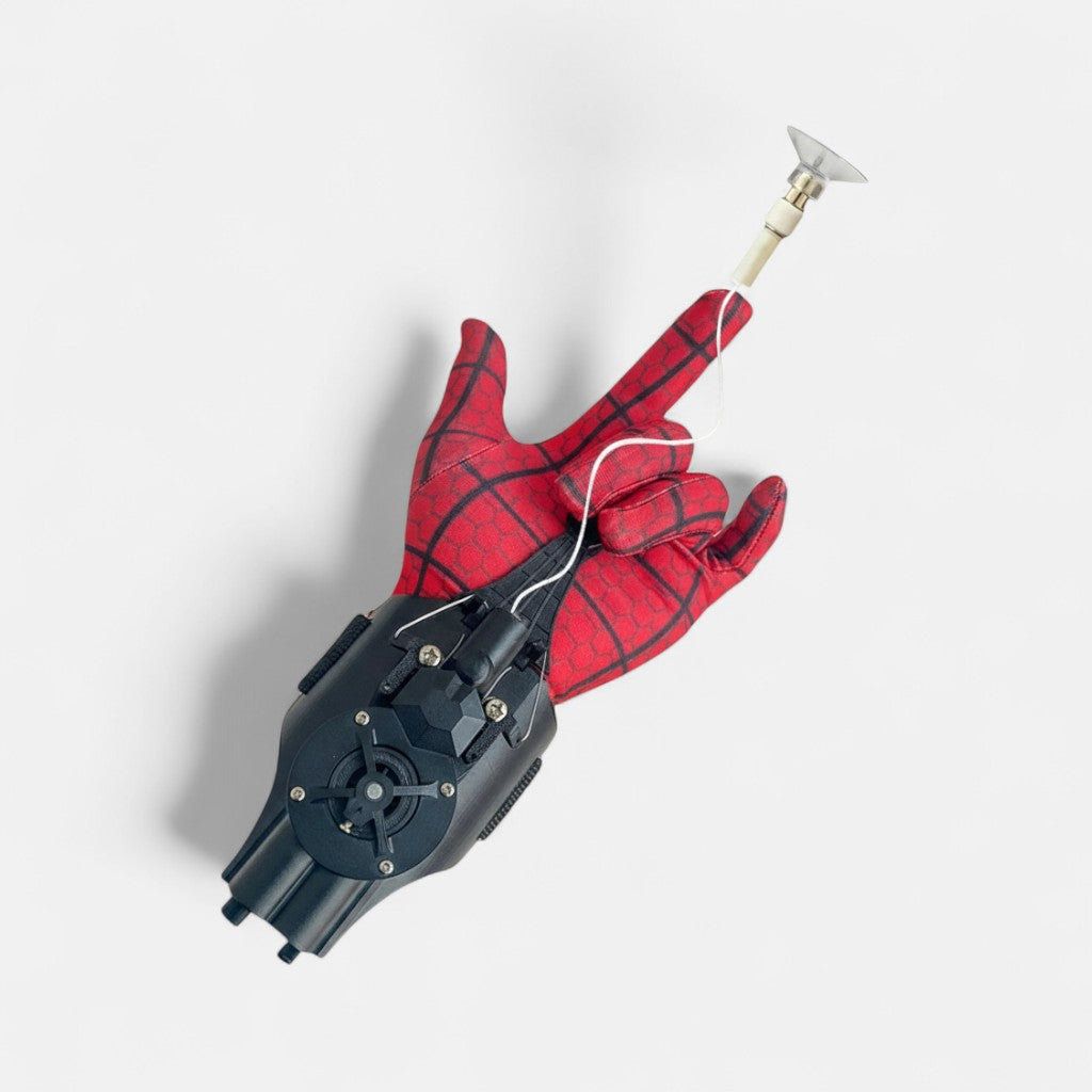 Spider-Man web shooter in black with an included red Spider-Man glove displayed on a plain white background.